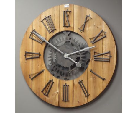 Large circular planked pine wall clock with Roman numerals, skeleton simulated workings with battery movement, Diameter - 80c