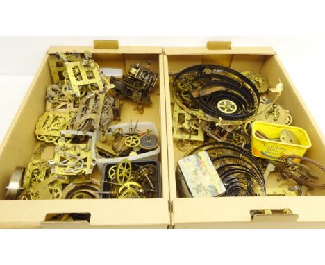 Large quantity of various American and English clock movements, clock parts, springs etc in two boxes