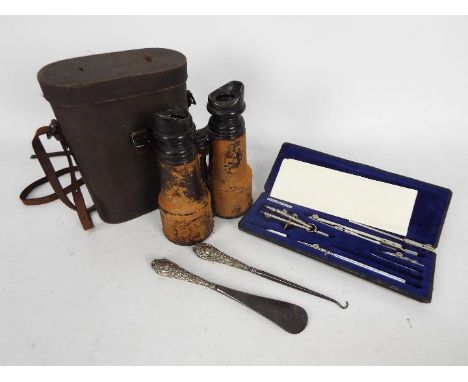 A pair of Army &amp; Navy field glasses contained in case, a technical drawing set, silver handled button hook and shoe horn.