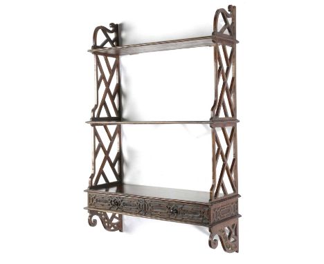 A SET OF ANGLO-CHINESE PADOUK WALL SHELVESIN CHINESE CHIPPENDALE STYLE, PROBABLY 19TH CENTURYwith three shelves above two dra