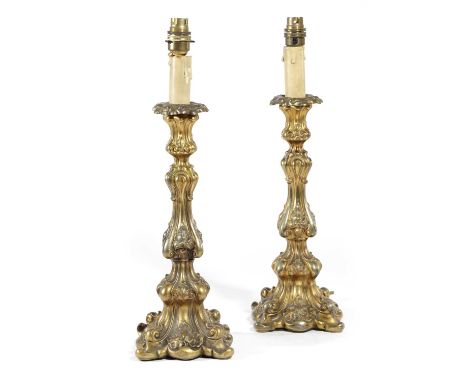 A PAIR OF GILT METAL CANDLESTICK TABLE LAMPSIN ROCOCO STYLE, LATE 19TH CENTURYof scrolling form with foliate decoration, fitt