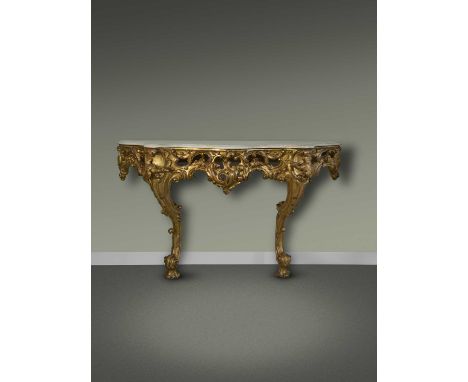 A GILTWOOD CONSOLE TABLEIN THE MANNER OF MATTHIAS LOCK,the serpentine white marble top above a pierced frieze, carved with sc