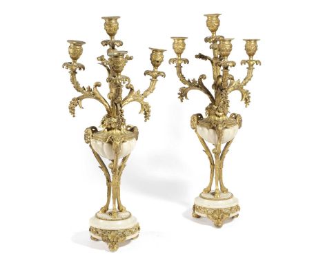 A PAIR OF FRENCH ORMOLU AND WHITE MARBLE FOUR LIGHT CANDELABRAIN LOUIS XVI STYLE, LATE 19TH CENTURYeach with urn nozzles on f