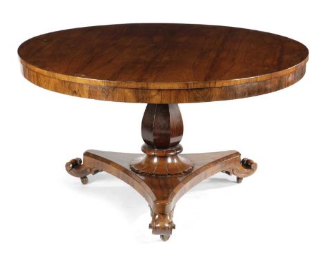 λ  AN EARLY VICTORIAN ROSEWOOD BREAKFAST TABLEC. 1840-50the circular tilt-top above a faceted baluster stem and a triform pla