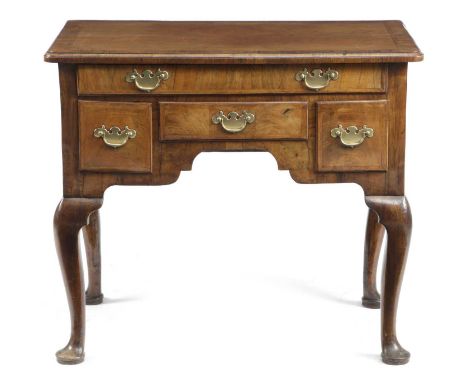 A GEORGE II WALNUT LOWBOYC.1730-35with cross and feather banding, the quarter veneered top with a caddy moulded edge above an