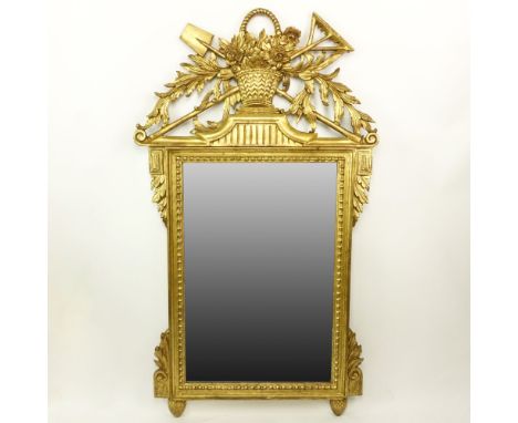 Early 20th Century Louis XVI Style Gilt Wood Hall Mirror. Top finial depicts a floral bouquet in basket with gardening tools.