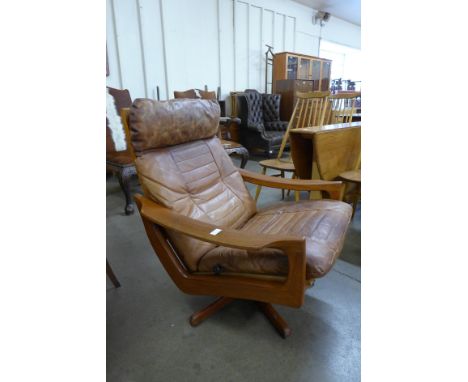 A Norwegian Lied Mobler teak and brown leather revolving and reclining lounge chair, designed by Soda Galvano *Please note th