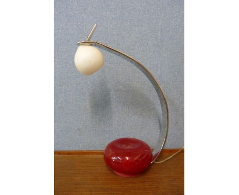 A contempoary chrome and red glass desk lamp 