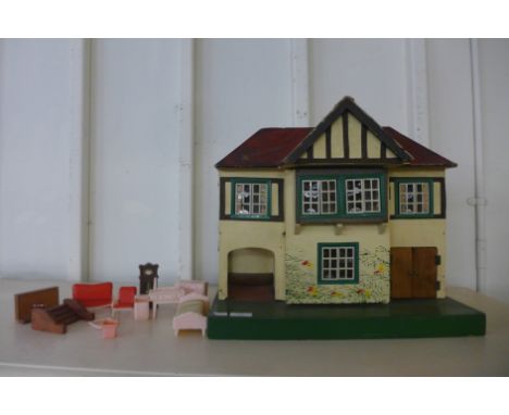 A vintage child's Tri-ang dolls house with accessories 