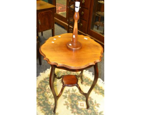 An early 20th century mahogany shaped circular occasional table, shelf stretcher, c.1920;  a mid 20th century teak lamp base 