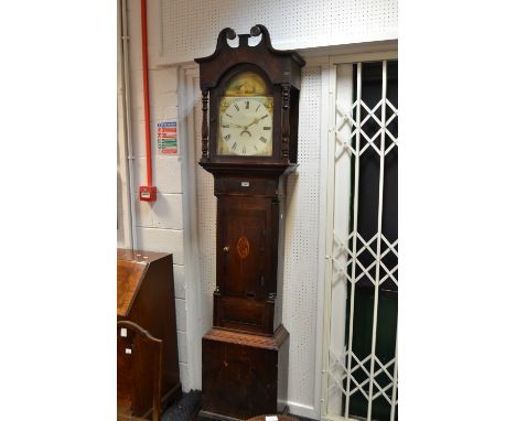 A Victorian oak inlaid longcase clock, curly pediment with carved patera to hood, arched dial flanked by turned columns, pain