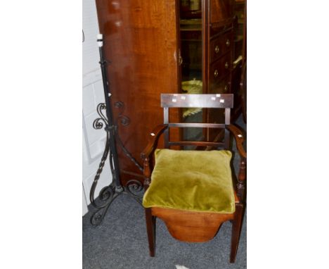 A 20th century black wrought iron standard lamp;  a 19th century oak commode chair (2)
