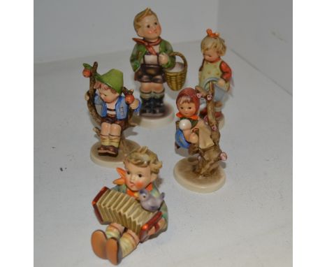 A Goebel figure, designed by MJ Hummel, Apple Tree Girl;  others, Apple Tree Boy;  Girl with a watering can;  Boy with a conc