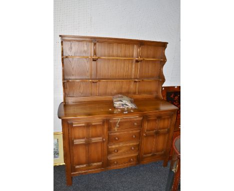 A mid 20th century Ercol Dresser, open top, two doors flanking four drawers