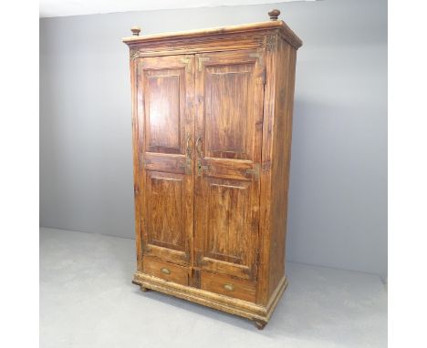 An Indian hardwood two-door wardrobe with shelf fitted interior and two frieze drawers to base. 100x178x51cm. 