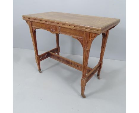 An Arts and Crafts style oak fold-over card table, with paper label for Kennard, cabinet maker of St. Leonards. 89x74x45cm 