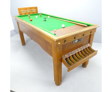 An early 20th century bar billiards table, with cues, balls and scoreboard, operated on a sixpence, with mechanical movement 