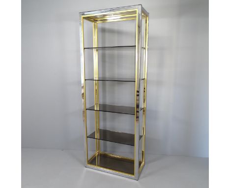 A mid-century Hollywood Regency style display shelf, with chrome and brass frame and six smoked glass shelves, by Renato Zevi