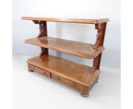 A Victorian mahogany three-tier buffet, with two drawers, carved and pierced decoration and raised on melon carved feet. 135x