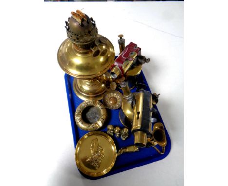 A tray of antique and later brass wares to include Duplex oil lamp, Burmos blow lamp, ash tray, ornaments etc 