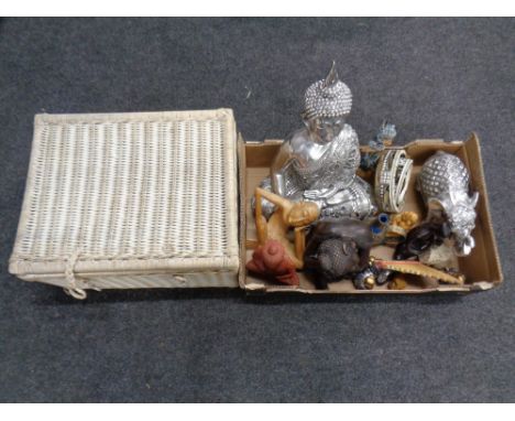 A box containing ornaments to include Buddha figures, tambourines, wooden pipes, together with a wicker picnic hamper  