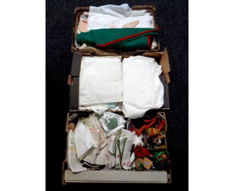Three boxes containing a large quantity of assorted vintage linens, dolls of the world  