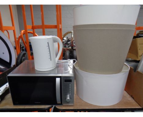 A Kenwood microwave together with a kettle and four standard lamp shades  