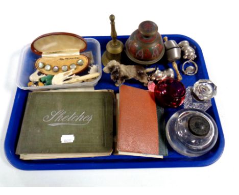 A tray containing miscellaneous to include baby rattles, a painted Spelter figure of a Spaniel, sketchbook, loose stamps, Wat