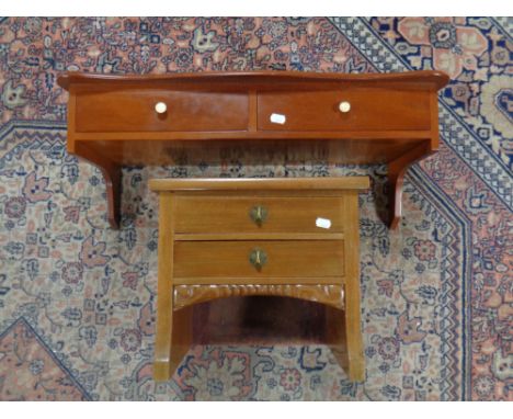 A mahogany wall shelf fitted two drawers and a further miniature chest 