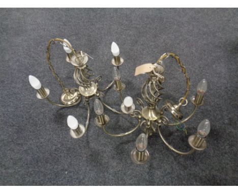 A pair of contemporary six branch light fittings in an antique brass finish  