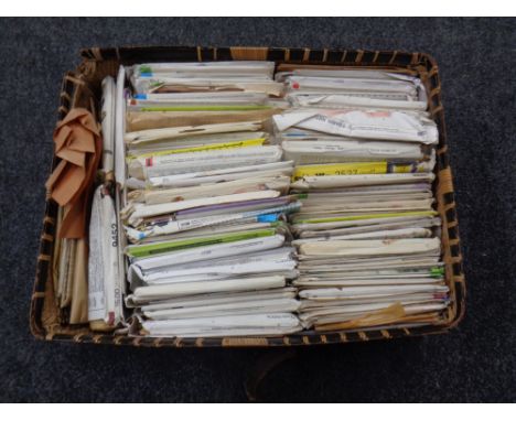 A wicker basket containing a quantity of vintage knitting patterns 