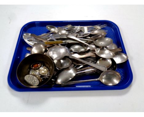 A tray containing two silver forks together with a quantity of plated cutlery together with a brass Indian bowl containing br