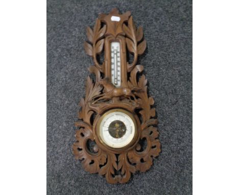 A carved Black Forest style barometer 