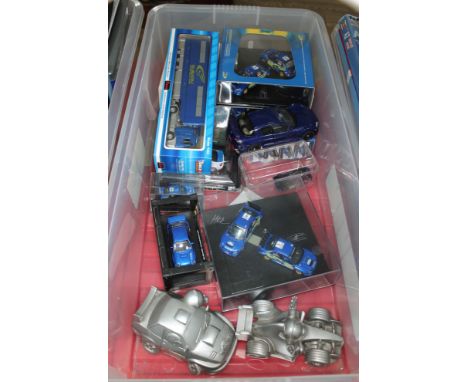 A box of various die-cast and composite model cars, mainly related to Subaru. 