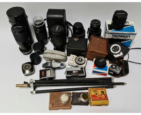 A box of camera equipment including lenses, tripod, vintage light meters etc. 