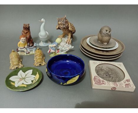 A box of mixed ceramics including Moorcroft dishes, Poole plates, Wade figures, Nao, Goebel etc. 