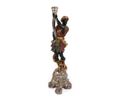 A Venetian Carved and Painted Wood Torchere, in 18th century style, as a blackamoor holding a cornucopia supporting a gilt me