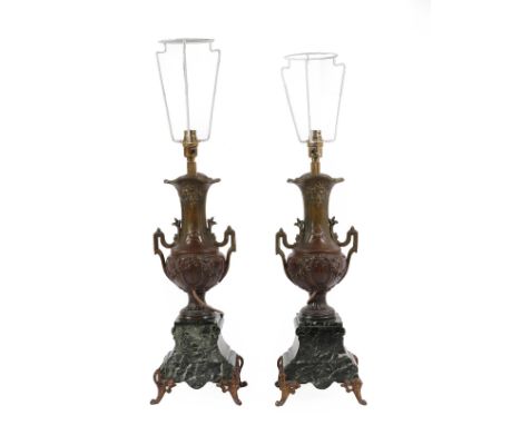 A Pair of French Patinated Spelter and Verdi Antico Marble Lamps, circa 1900, of urn form with twin loop handles and ribbon t