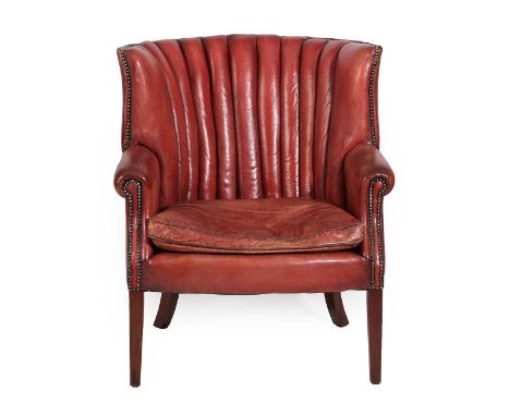 A 20th Century Barrel Shaped Library Armchair, covered in close-nailed red leather, with rounded arms, squab cushion, and a c