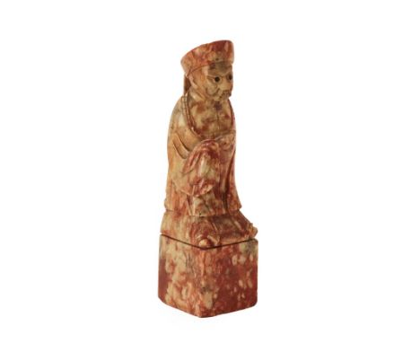 A Chinese Soapstone Seal, late Qing Dynasty, carved as a dignitary on a rectangular block, 18cm high