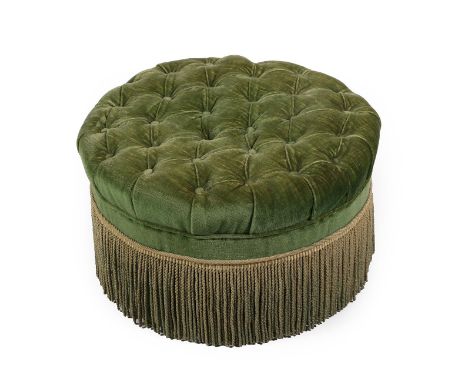 An Early 20th Century Pouffe, of circular form, covered in buttoned green velvet with overstuffed seat and gold tassel fringe