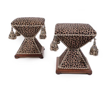 A Pair of 19th Century Mahogany Framed Stools, each with square seat and of exaggerated waisted form, raised on flattened bun