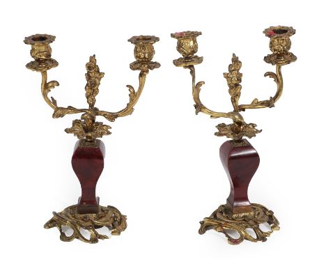 A Pair of Gilt Metal Mounted Tortoiseshell Candelabra, 19th century, with leaf cast scroll sockets, branches and finials, on 