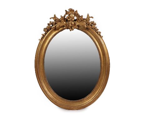 A French Late 19th/Early 20th Century Giltwood and Composition Mirror, in the Louis XVI style, the later oval bevelled plate 