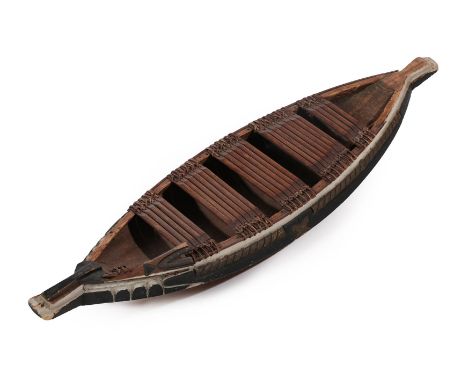 A Late 19th/Early 20th Century African Model of a Wood-Hewn Boat, with panels of bound wooden slats, 94cm long