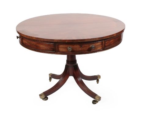 A George III Mahogany Drum Top Library Table, early 19th century, the circular crossbanded top above four frieze drawers, rai