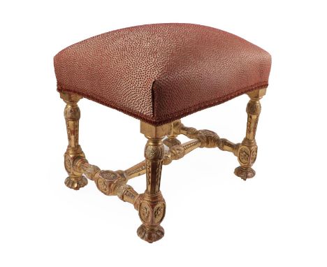 A George II Style Carved Giltwood Stool, overstuffed seat recovered in red spotted fabric, raised on acanthus carved and flow