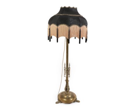 A Victorian Telescopic Brass Standard Lamp, the reeded stem with applied swag work decoration above the cast acanthus leaf ca