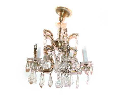 A Cut Glass Five-Light Chandelier, with baluster stem, scroll branches and fluted sconces hung with cut glass swags and drops