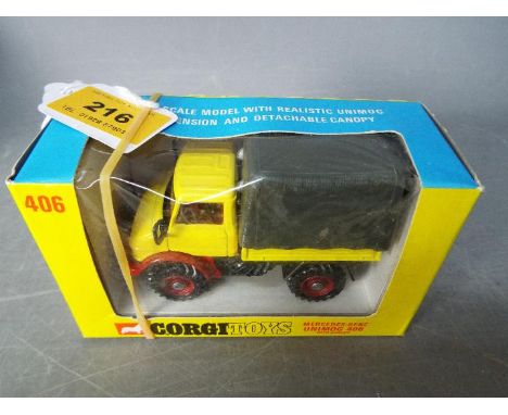 Corgi Toys - A boxed Corgi Toys #406 Mercedes Unimog 406 with Canopy. The model in yellow and red with red interior, red hubs